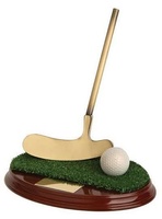 Trofeo golf pelota, césped y palo